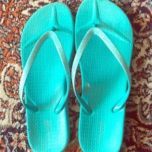 Blue glittery flip flops